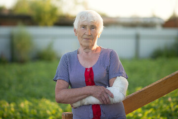 An elderly woman with a broken arm.A cast on a woman's arm.