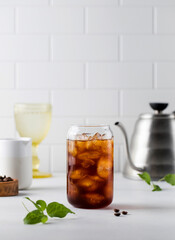 Cold black coffee with ice cubes on a white background. Coldbrew. Summer drinks.