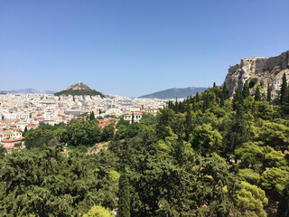 Fototapeta na wymiar View of the Parthenon on the Athenian Acropolis and Mount Lycabettus, seen from the Areopagus Hill in Athens, Greece.