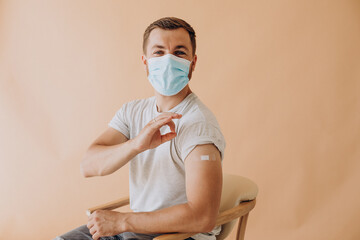 Young man got vaccinated at hospital and sitting in chair