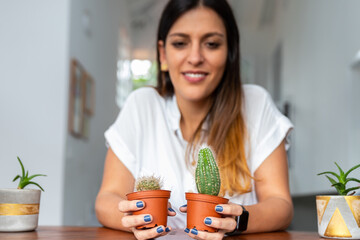 selective focus of succulents with an out-of-focus woman in the background