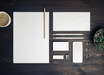 Blank branding identity set on wood table background. Corporate stationery template. Top view. Flat...