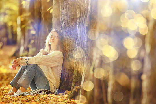 girl sitting autumn park, autumn season september in the forest