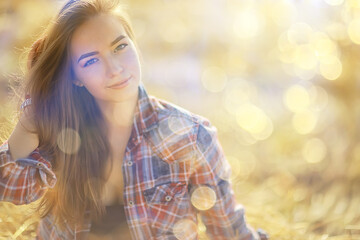 Naklejka premium summer sunny portrait of a happy girl, female happiness sun glare straw field country style