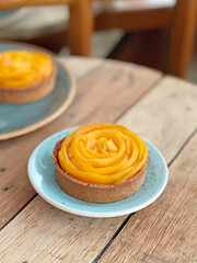 Vertical closeup shot of a mango tart on a table
