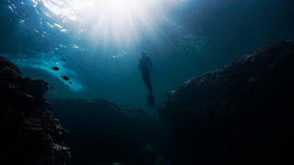 Fototapeta na wymiar Freediver emerging up to surface