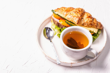 Healthy breakfast concept. Morning good mood with tea and croissant