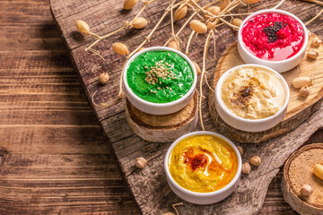 Chickpea hummus backdrop, assorted flavor on vintage wooden table