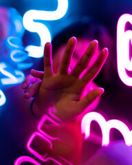 Hand amongst neon lights