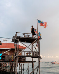 Girl on wooden deck in fishing village