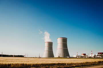 Fototapeta na wymiar Ostrovets, Grodno region, Belarus - July 21, 2021: Nuclear power plant against the blue sky. Concept of the nuclear energy.