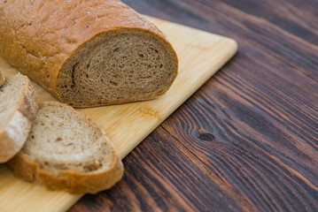 rye gray delicious bread on a wooden table. gluten-free product made from wheat rye flour. delicious fresh organic pastries.