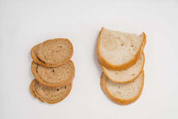 Fototapeta na wymiar pieces of bread are white and rye gray bread. comparison of the bread variety. gluten-free product