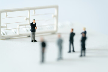 Obraz premium Miniature people A Businessman speech presentation on public stage on white background using as Success Business Due and New Technology products announcement partnership business development concept