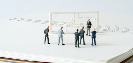 Miniature people A Businessman speech presentation on public stage on white background using as Success Business Due and New Technology product announcement partnership business development cover page