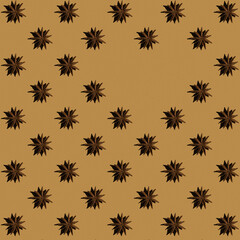 Pattern from anise stars with copy space on beige background