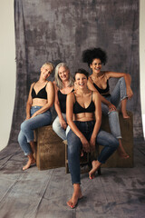 Full length shot of diverse women laughing together in a studio