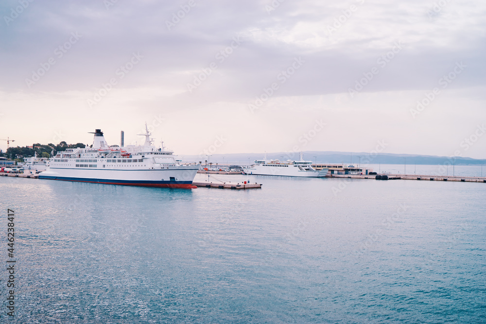 Wall mural Ferryboat loading by a port pier. Concept of transportation and traveling.