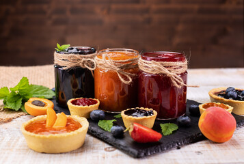 Jars with delicious summer fruits jam