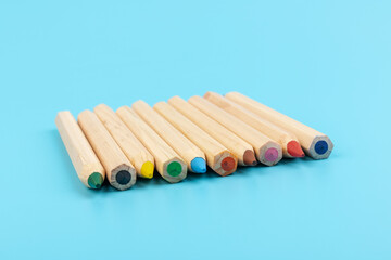 Wooden colorful ordinary pencils isolated on blue background