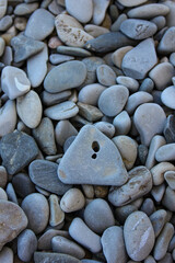 a stone with a hole on the beach