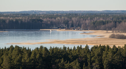 Aerial view of Usma lake in sunny winter evening without snow, Latvia.