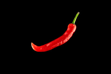 Cayenne chilli. Red hot chili paprika or spicy chile cayenne pepper isolated on black background. Fresh spice vegetable concept.