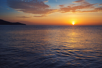 Beautiful seascape with sunset cloudy sky.