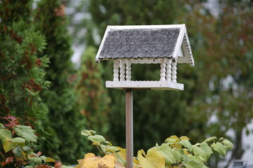 Bird house in the autumn garden