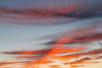 Red orange clouds on the sunrise sky.