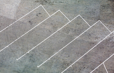 Fototapeta premium Aerial view of an empty parking lot without cars with markings on the asphalt