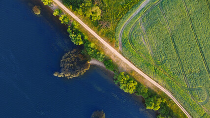 Aerial view of a beautiful green coast with a road near the sea