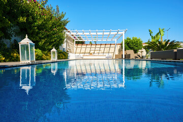 Swimming pool and patio of a residential Aegean or Mediterranean villa.