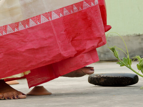 indian hindu marriage wedding rituals bride wearing sharee leg kicking pushing sil batta