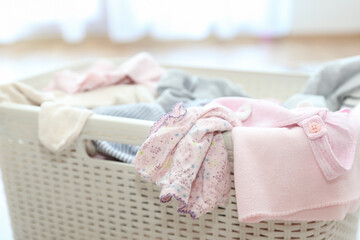 Baby clothes in laundry basket