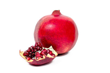 Juicy pieces of bright red cut pomegranate isolated on white background.