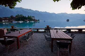 Wooden cafe tables on the bay of Brienz lake, Switzerland.