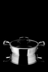 Moscow, Russia - 07/26/2020:
Saucepan for frying, with a glass lid, company Gipfel, on a black background