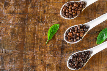 A collage of coffee beans in spoon showing various stages  through to roast