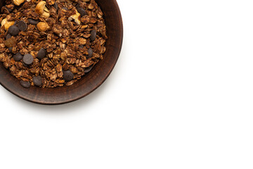 Chocolate granola cereal with nuts in a bowl background.