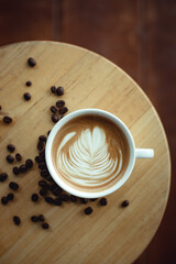 Selective focus cup of hot latte art coffee,focus at white foam