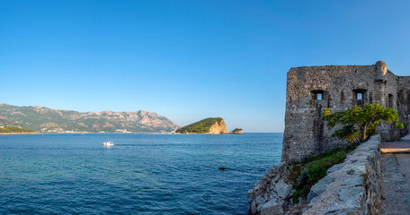 Fototapeta na wymiar Summer seascape with turquoise water of Adriatic sea and Sveti Nikola island from Budva city in Montenegro.