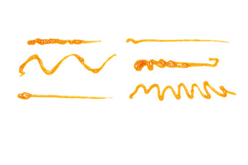 Orange apricot jam splashes isolated on white background. Top view.