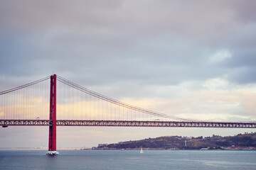 Beautiful landscape with suspension 25 April bridge bridge over the Tagus river in Lisbon, Portugal.