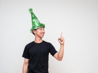 Portrait young man happy face with green hat point right finger above look at right hand and smile on white isolated background
