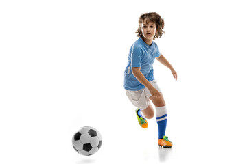 Young sportsman, football soccer player, child playing football isolated on white studio...