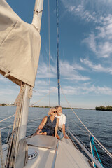 Romantic vacation and luxury travel. Senior loving couple sitting on the yacht deck. Sailing the river.