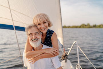 Romantic vacation and luxury travel. Senior loving couple sitting on the yacht deck. Sailing the...