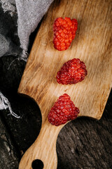 Fresh juicy raspberries in a wooden table. Summer still life with raspberries. A place to copy