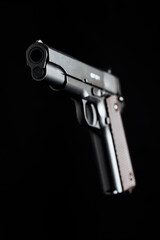 Colt 1911 pistol on the black background.